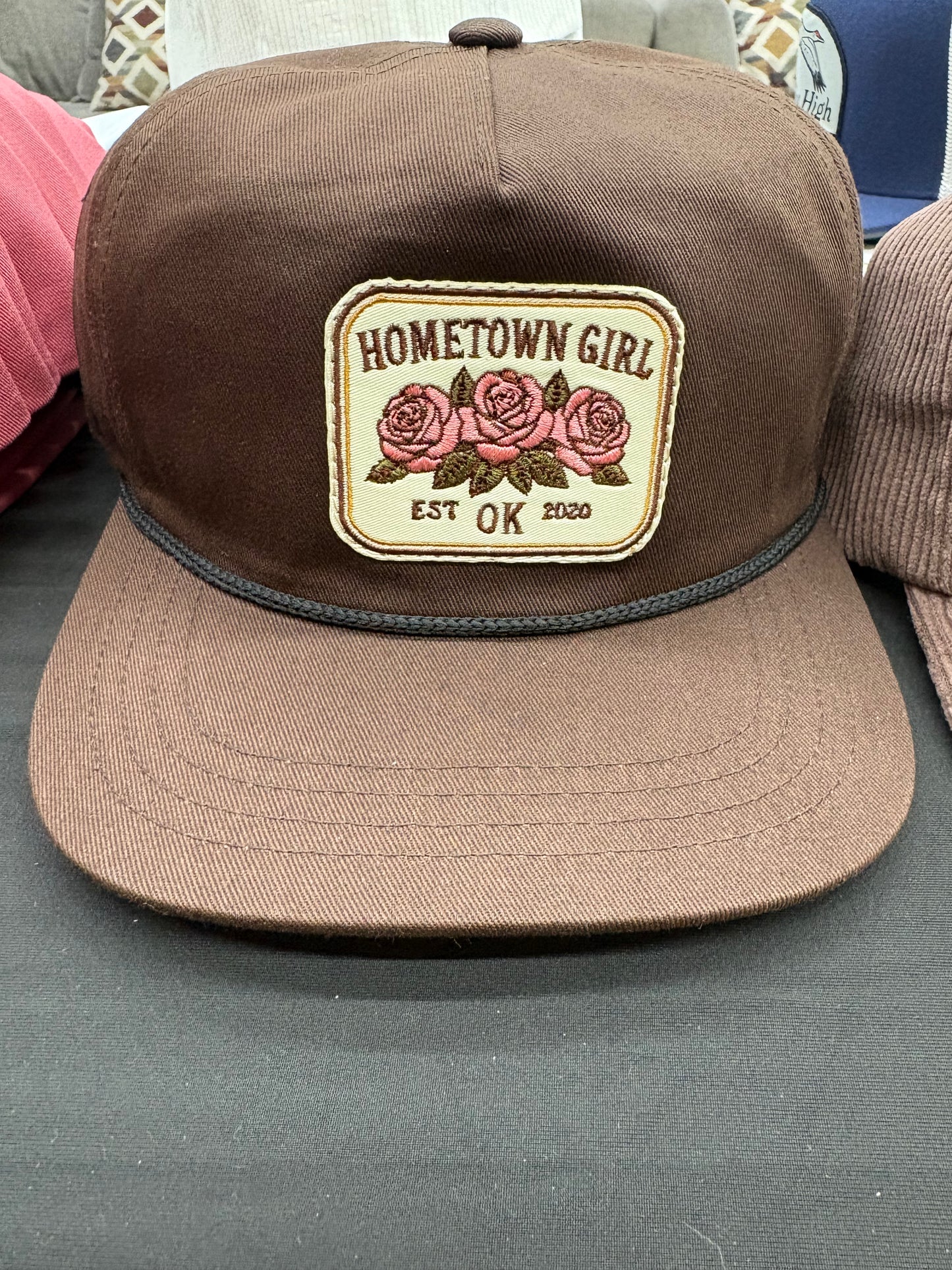 Brown cap with 'Hometown Girl' patch featuring roses 